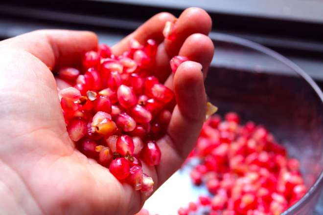 Pomegranate seeds in hand