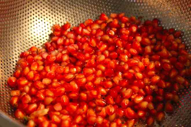 Pomegranate seeds in strainer